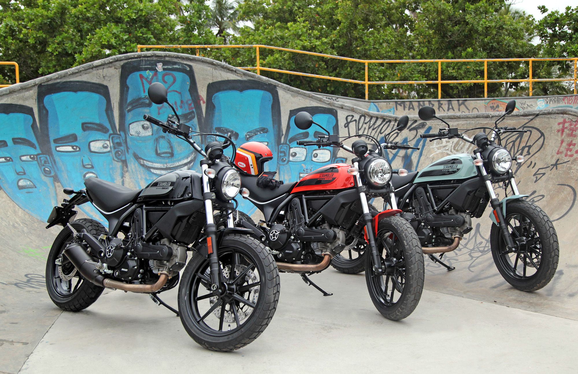 Four Ducati 400 Scramblers lined up on a skate ramp