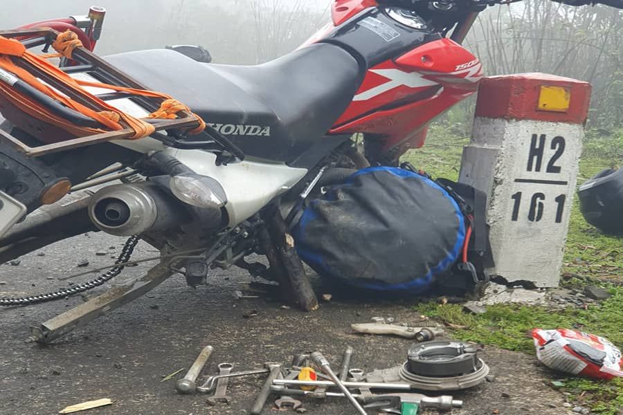 Red Honda Dirt Bike being repaired on the side of a road