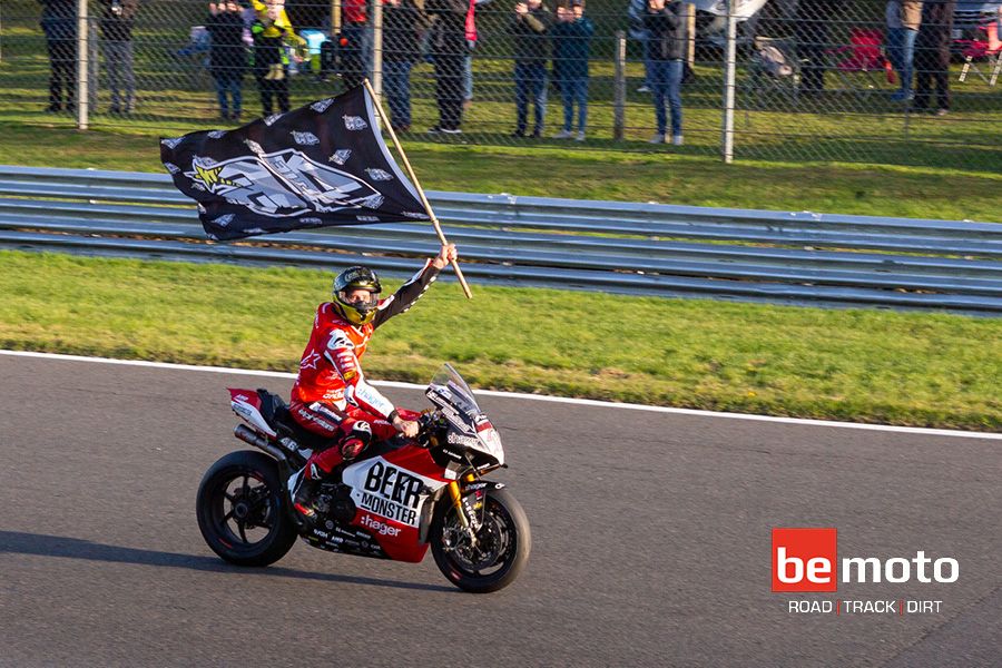 tommy Bridewell BSB Champion riding around Brands Hatch with a flag