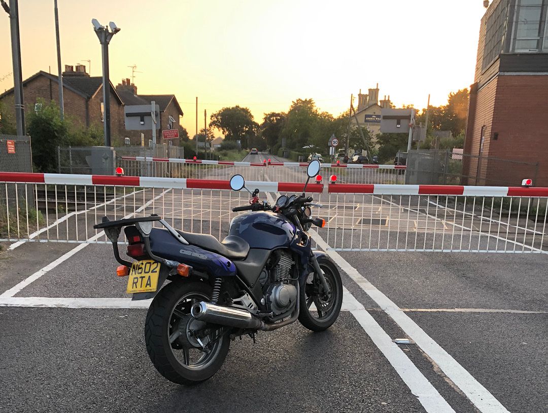 Honda CB500 parked at level crossing