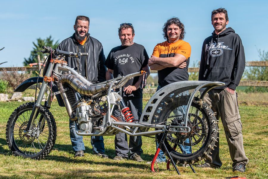 Team LCH standing behind their CR1000 hill climbing dirt bike