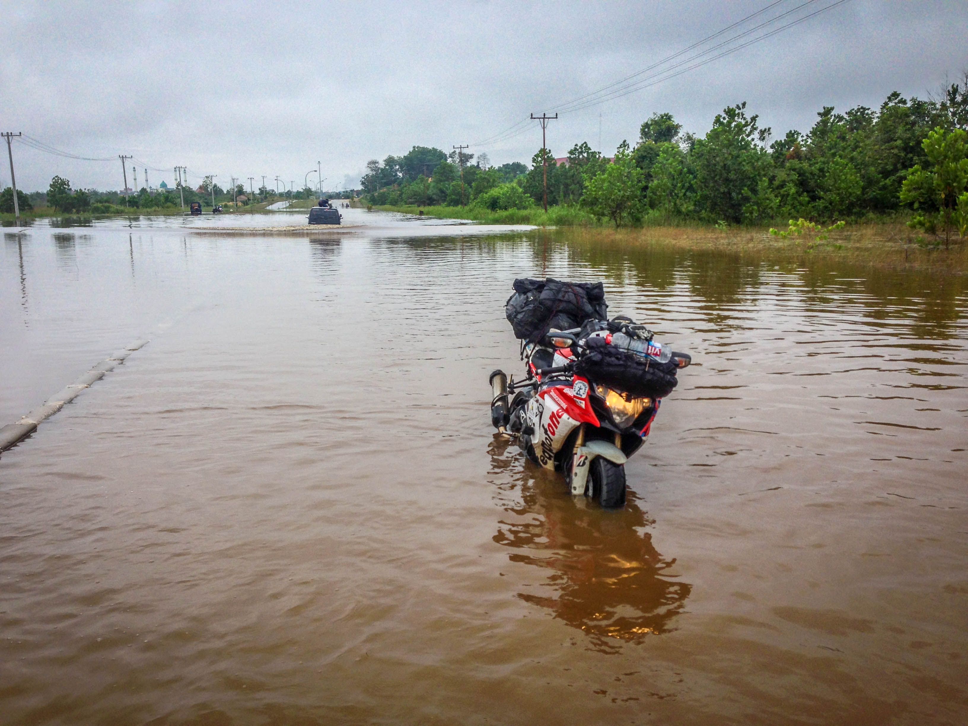 Motorcycle on flooded road Bruce Smart TeaPotOne