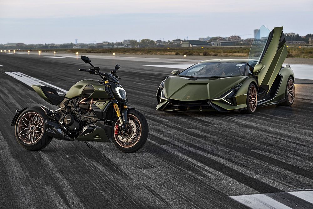 Ducati Diavel 1260 and Lamborghini Sian parked on a runway