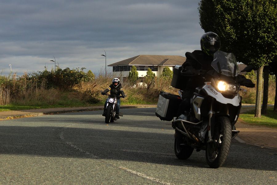 Motorcycles riding along a road in single file