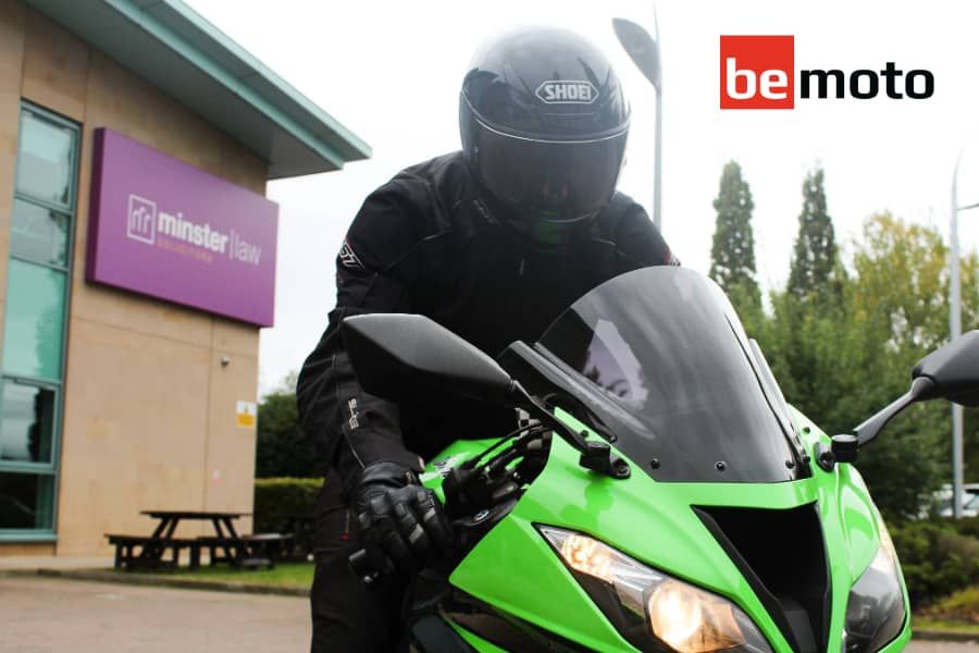 Green motorcycle outside Minster Law offices