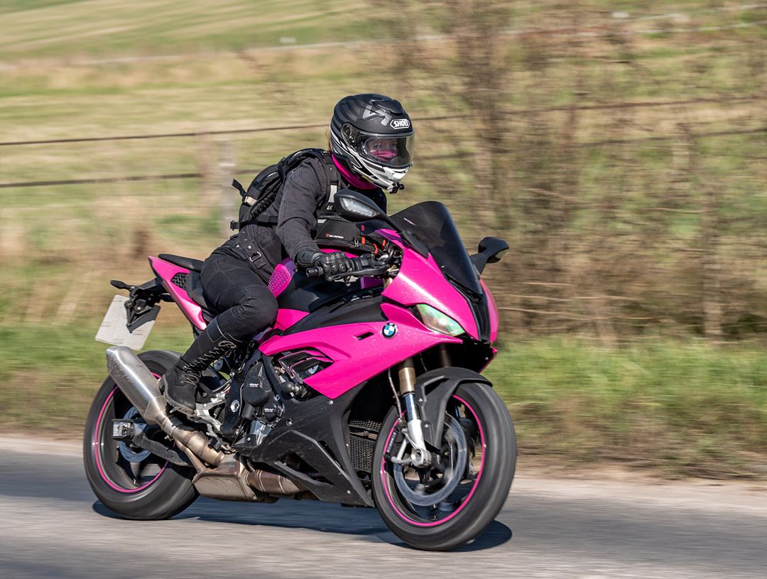 R1Liz riding her pink BMW bike on the road