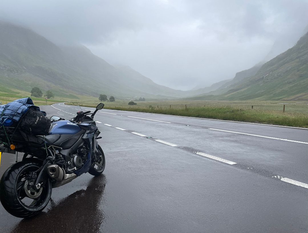 Suzuki GSXS-1000GT parked in the wet and cloudy Scottish hills