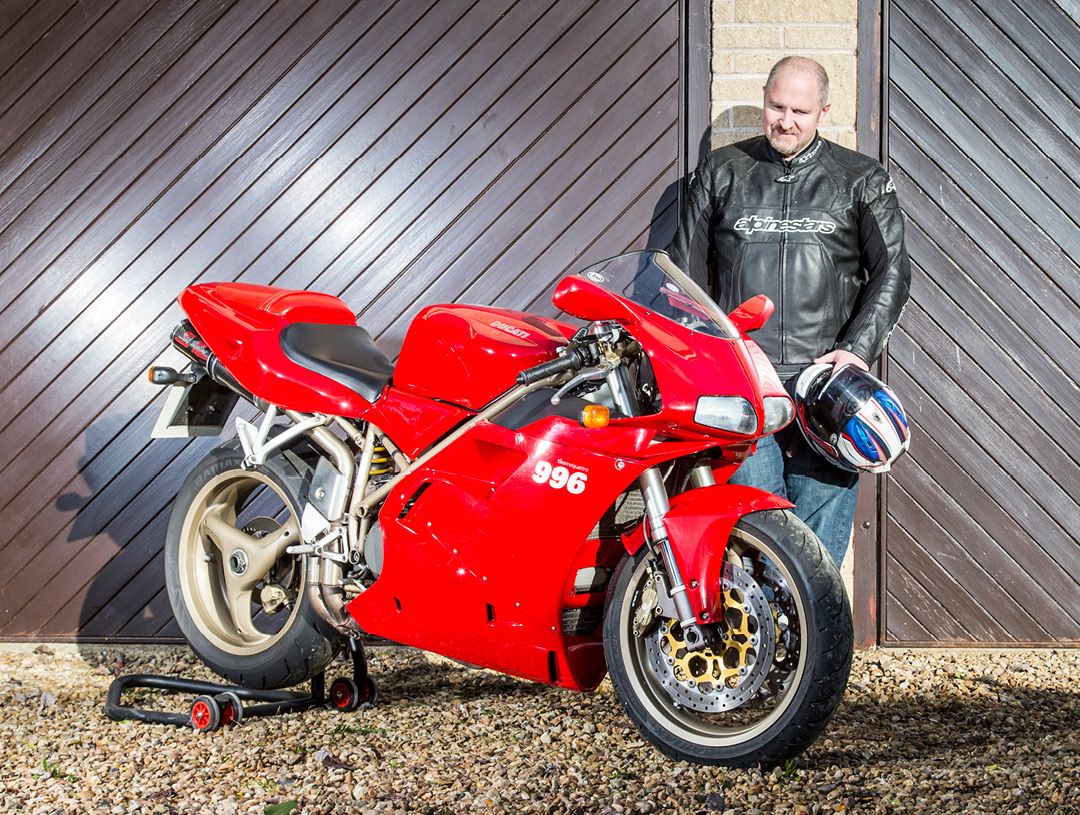 Ducati 996 on paddock stand with Richard Newland