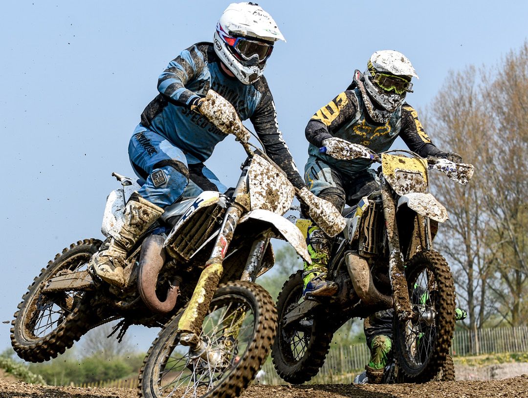 Two motocross riders side by side