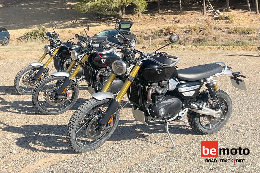 Three Triumph Scrambler 1200s parked together on dirt