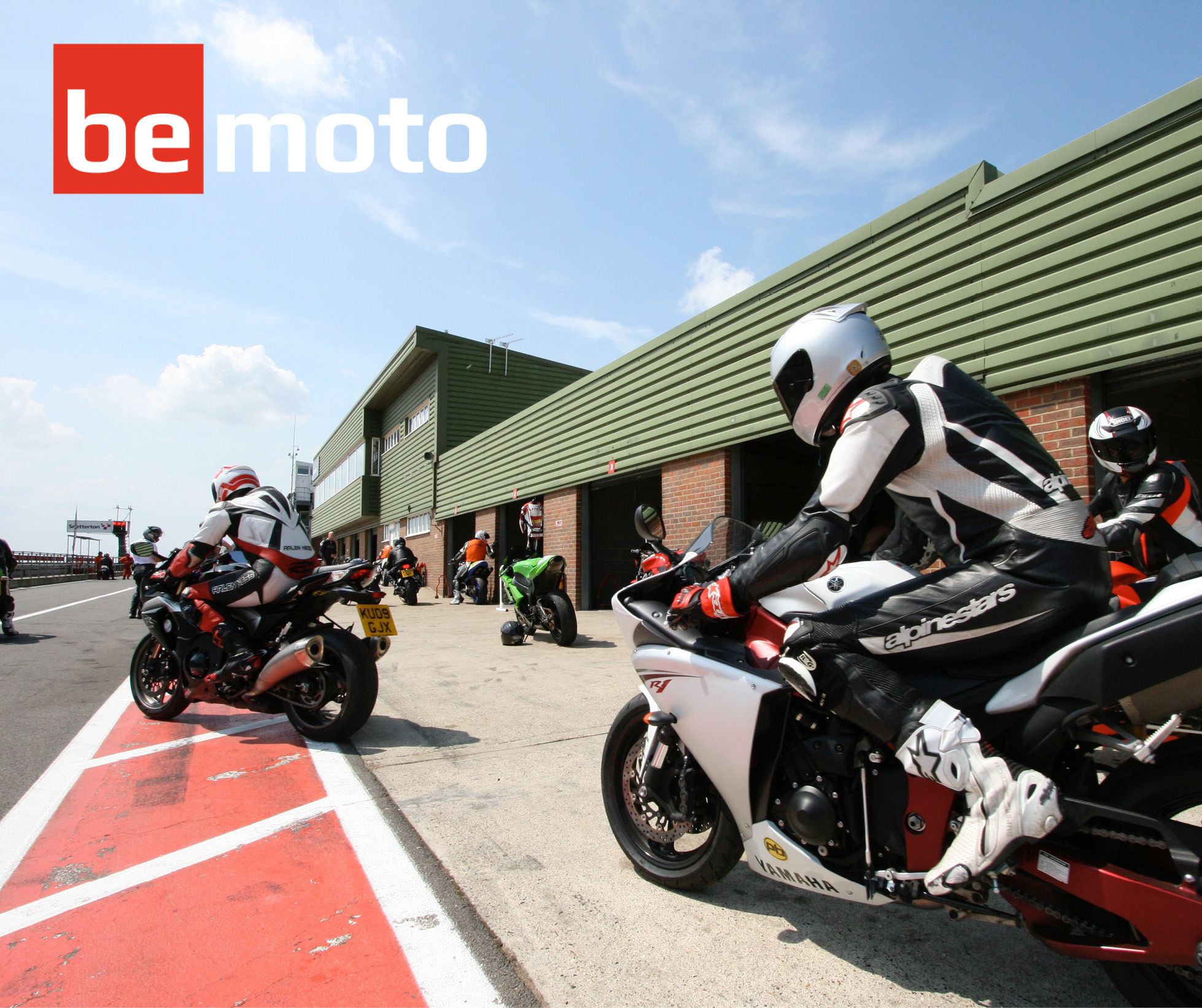 Motorbikes entering the pit lane at a track day