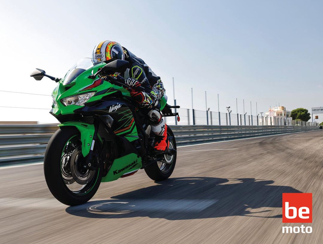 A green Kawasaki ZX4RR being ridden on a straight track 