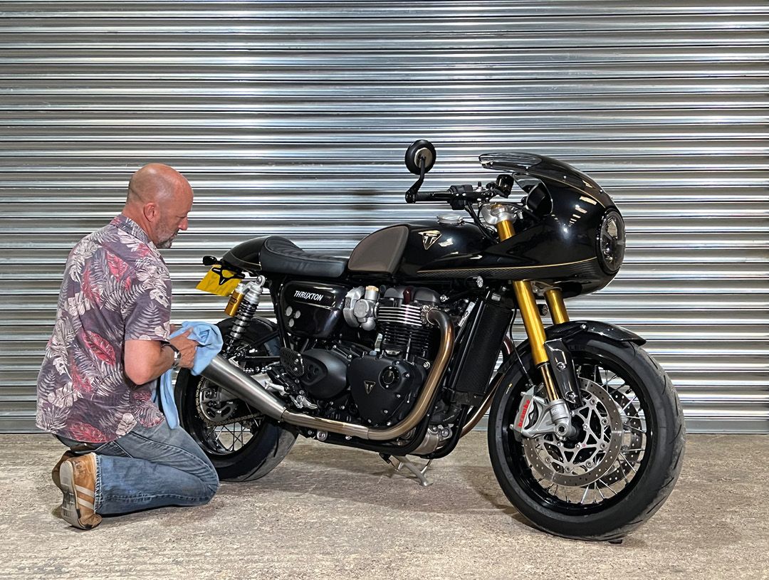 Triumph Thruxton in black being polished