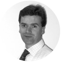 A monochrome headshot photograph of one of the managing directors of BeMoto, Ben Blake.