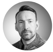 A monochrome headshot photograph of one of the managing directors of BeMoto, Scott Gorman.
