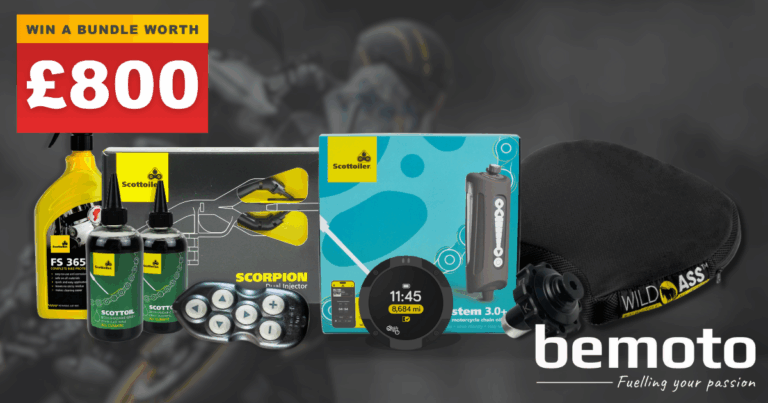 Promotional image for a BeMoto giveaway featuring a motorbike touring bundle worth £800. Products include Scottoiler FS 365 cleaner, chain oil, Scorpion dual injector kit, eSystem 3.0 electronic chain oiler, Beeline Moto II navigation system, and a Wild Ass motorcycle seat cushion. The BeMoto logo and slogan 'Fuelling your passion' are displayed in the bottom right corner.