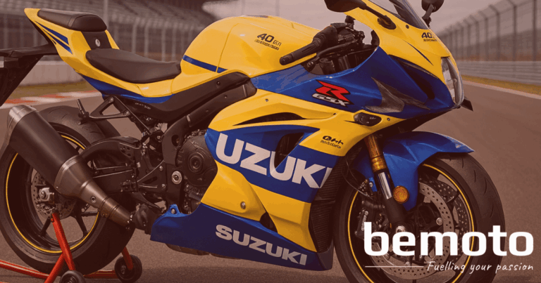 A high-resolution 3D render of the New Suzuki GSX-R1000R 40th Anniversary Edition in Pearl Ignite Yellow and Stellar Blue, featuring official anniversary decals. The bike is slightly cropped, positioned on a paddock stand at a race circuit, and showcasing its aerodynamic bodywork and performance components. The BeMoto logo is pictured in the bottom right corner.