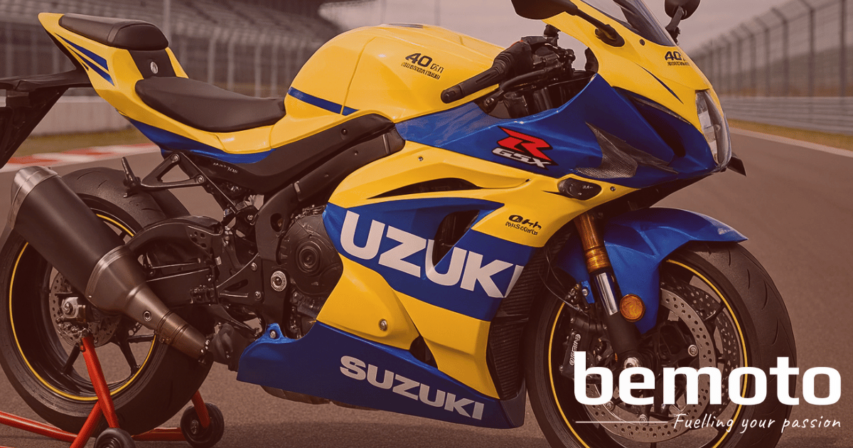 A high-resolution 3D render of the New Suzuki GSX-R1000R 40th Anniversary Edition in Pearl Ignite Yellow and Stellar Blue, featuring official anniversary decals. The bike is slightly cropped, positioned on a paddock stand at a race circuit, and showcasing its aerodynamic bodywork and performance components. The BeMoto logo is pictured in the bottom right corner.