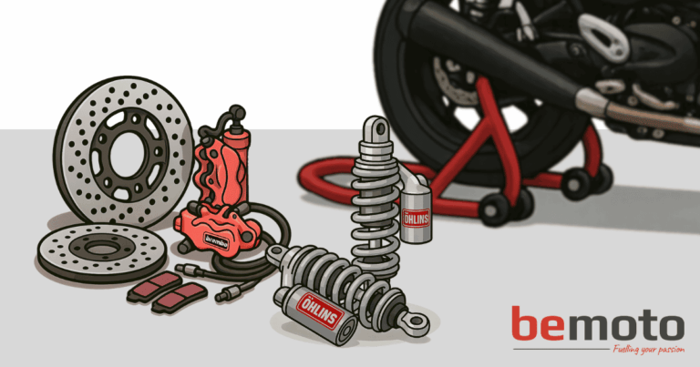 Cartoon-style illustration showing motorcycle modifications laid out in front of a bike on a paddock stand. On the left are two perforated brake discs, a red Brembo brake caliper with attached hose, and two sets of brake pads. In the centre are two Öhlins rear shocks, one standing upright and the other lying down. In the background, part of a motorcycle rear wheel and red paddock stand is visible. The scene has a light grey floor and white background, with the BeMoto logo in the bottom right corner and the tagline “Fuelling your passion.”