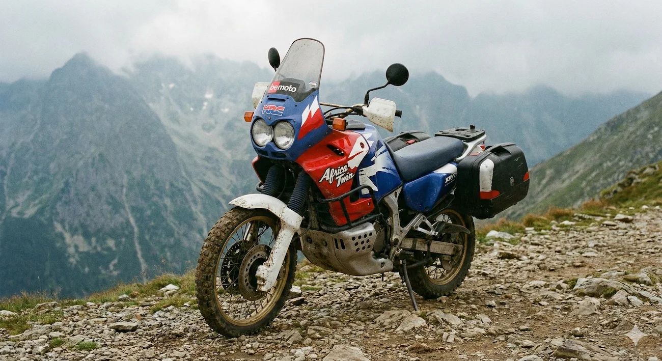 Classic Honda Africa Twin adventure bike on a dirt track.