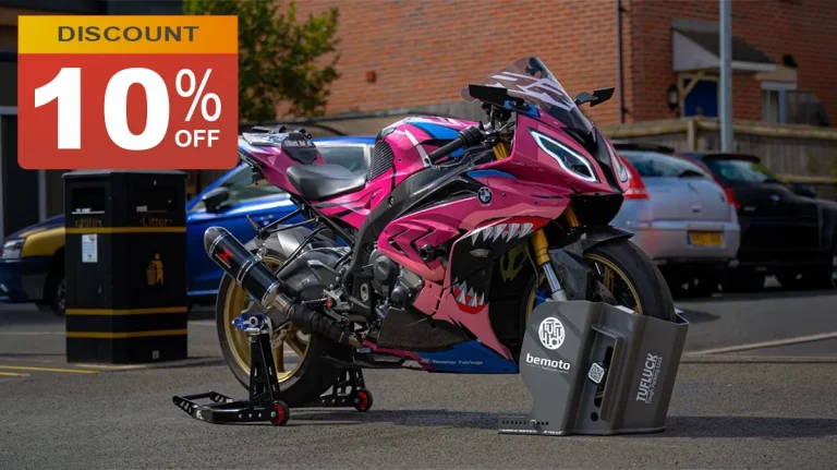 High performance sports motorcycle secured with a TufLuck heavy duty parking lock featuring BeMoto branding, parked in an urban residential setting. A prominent "10% off discount" box is displayed in the top-left corner with a red background and gold header.