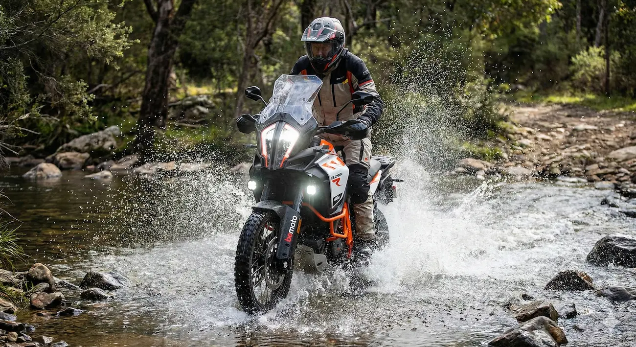 Modern adventure motorcycle riding through a river.