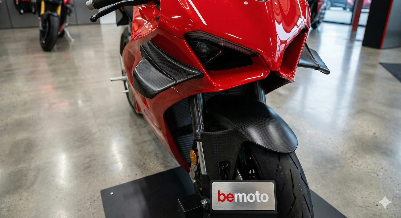 Modern superbike with aerodynamic winglets on a paddock stand.