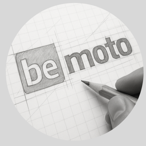 About BeMoto – Logo Creation Hand-drawn sketch of the BeMoto logo in development, featuring the word "be" inside a shaded square and "moto" in lowercase beside it, all on graph paper with construction lines and a pencil in hand—illustrating the creative process behind the logo's clean, modern, and balanced design.